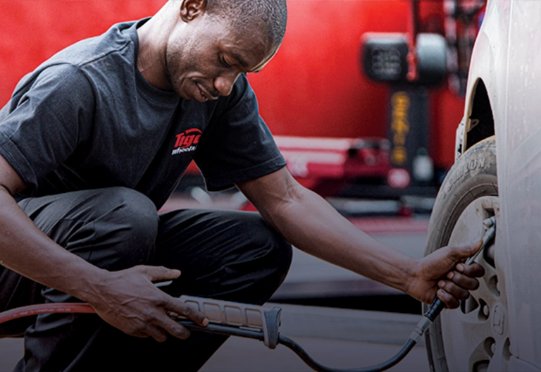 A Tiger Wheel & Tyre Technician pumping a tyre with nitrogen gas.